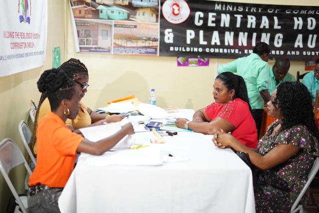 Central Housing and Planning Authority staffers assisting residents of Corriverton