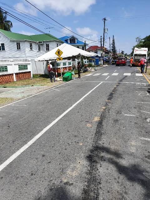 City Council sanitation workers busy clearing along Irving Street Georgetown.