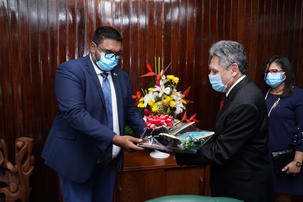 His Excellency, Dr. Mohamed Irfaan Ali, President of the Cooperative Republic of Guyana, receives a gift from His Excellency, José Omar Hurtado Conteras, Ambassador of the United Mexican States.