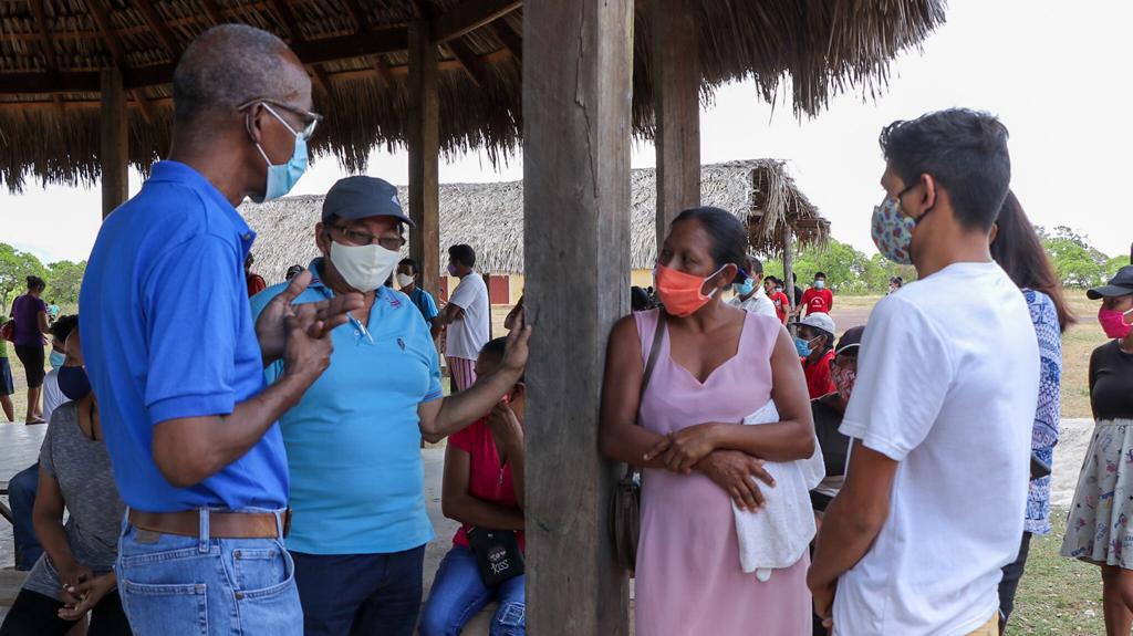 Minister of Labour, Hon. Joseph Hamilton and Region Nine Chairman Brian Allicock interact with residents
