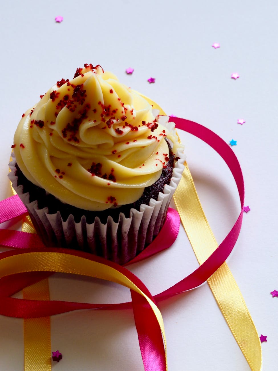 chocolate cupcake with white and red toppings