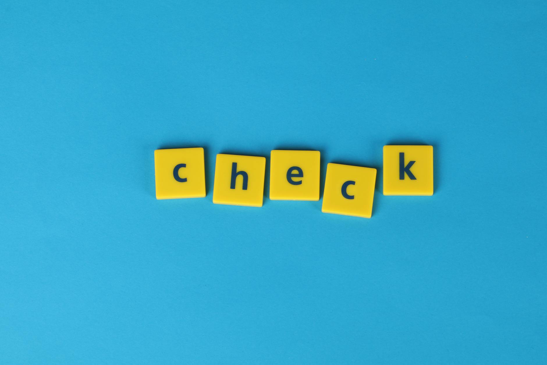 yellow letter tiles on blue background