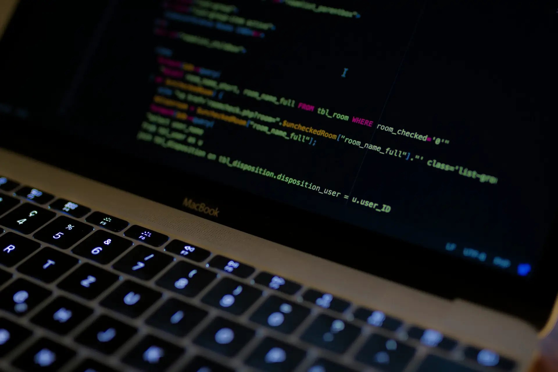 MacBook Pro with images of computer language codes