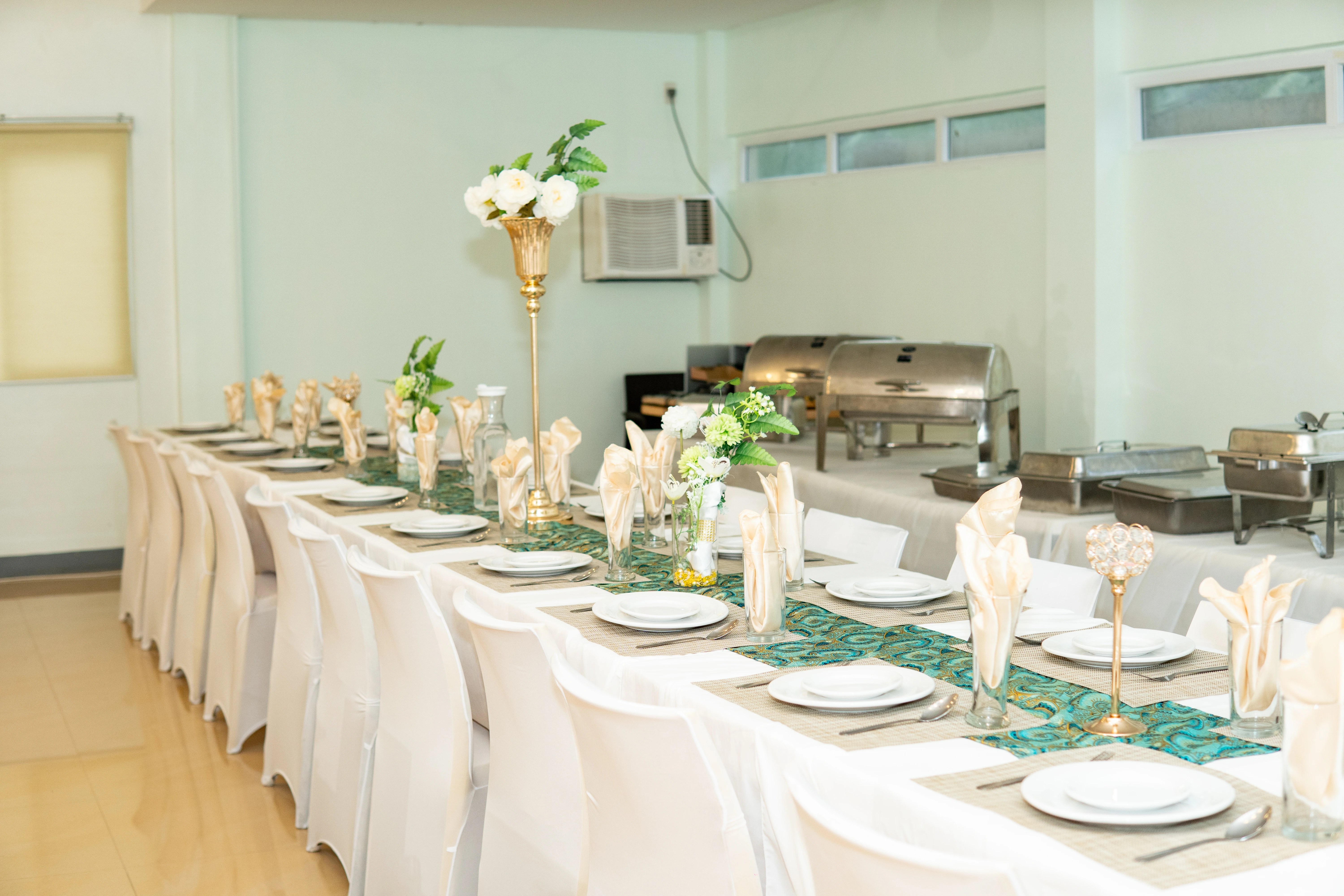 Function room arranged with long dining tables at Reef Waters Resort