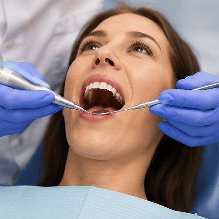 Patient receiving periodontal treatment and deep cleaning by dentist in St. Petersburg, FL.