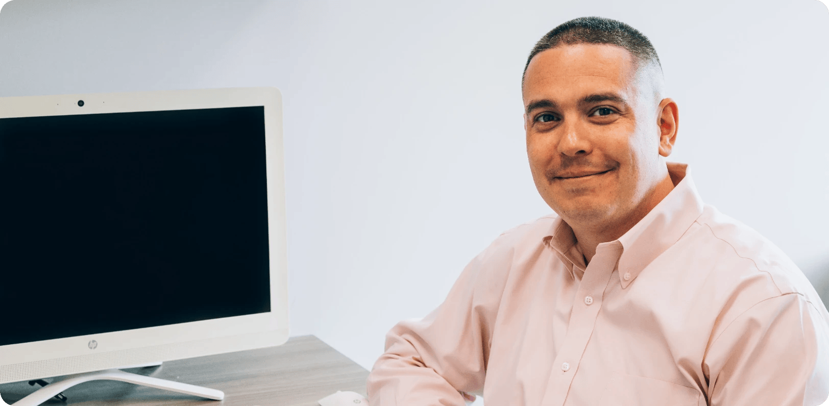 Dr. Greg Morrow sits at his desk in front of a computer where he meets patients