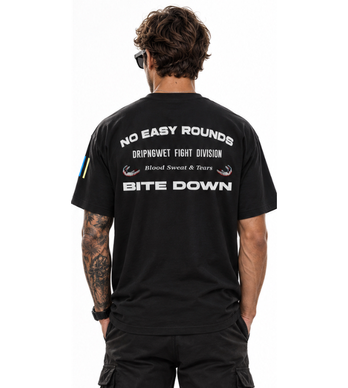 Male model wearing black Mouthguard Relaxed Tee with Bite Down boxing graphic