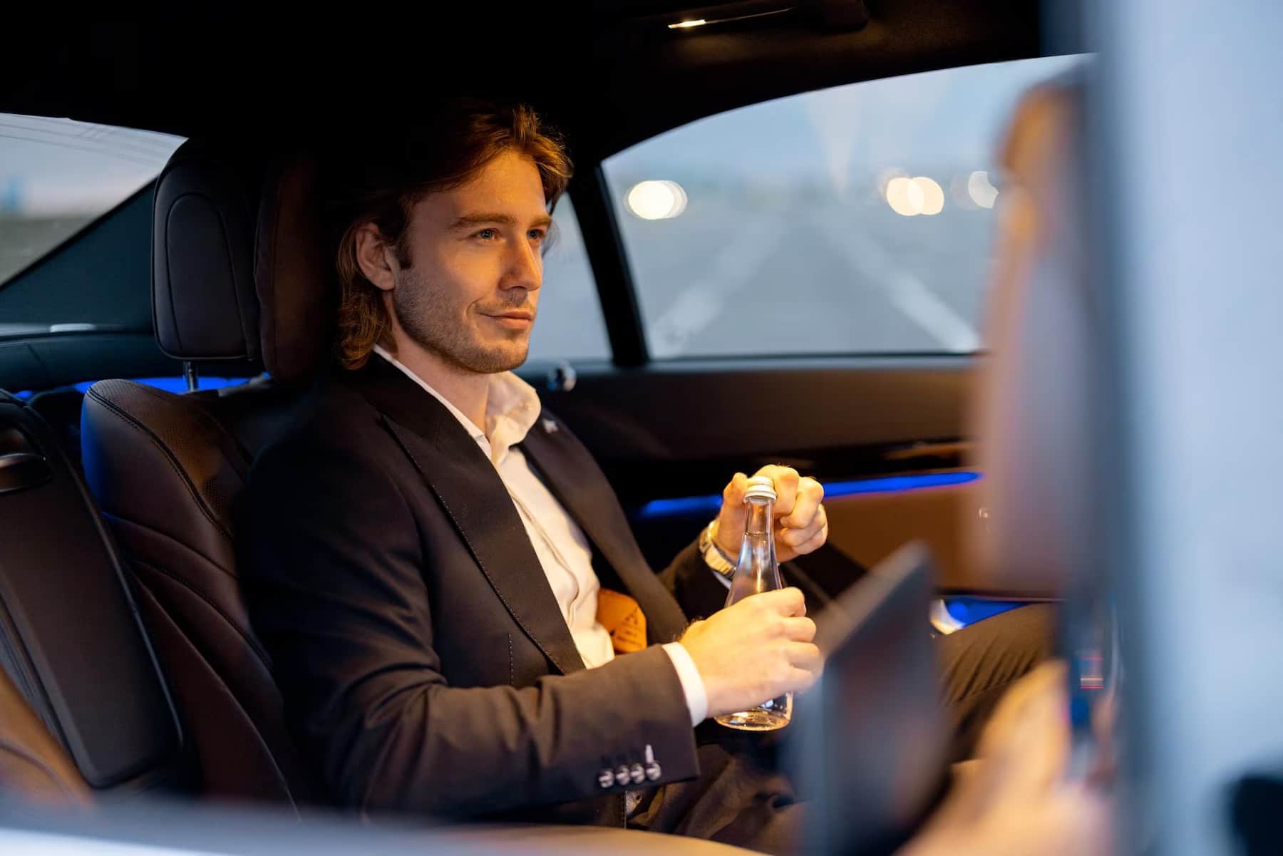 Private chauffeur in Switzerland driving a luxury Mercedes through the Swiss Alps