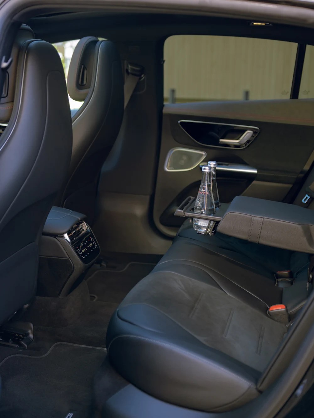Rear seat of the Mercedes EQE with a bottle of water ready