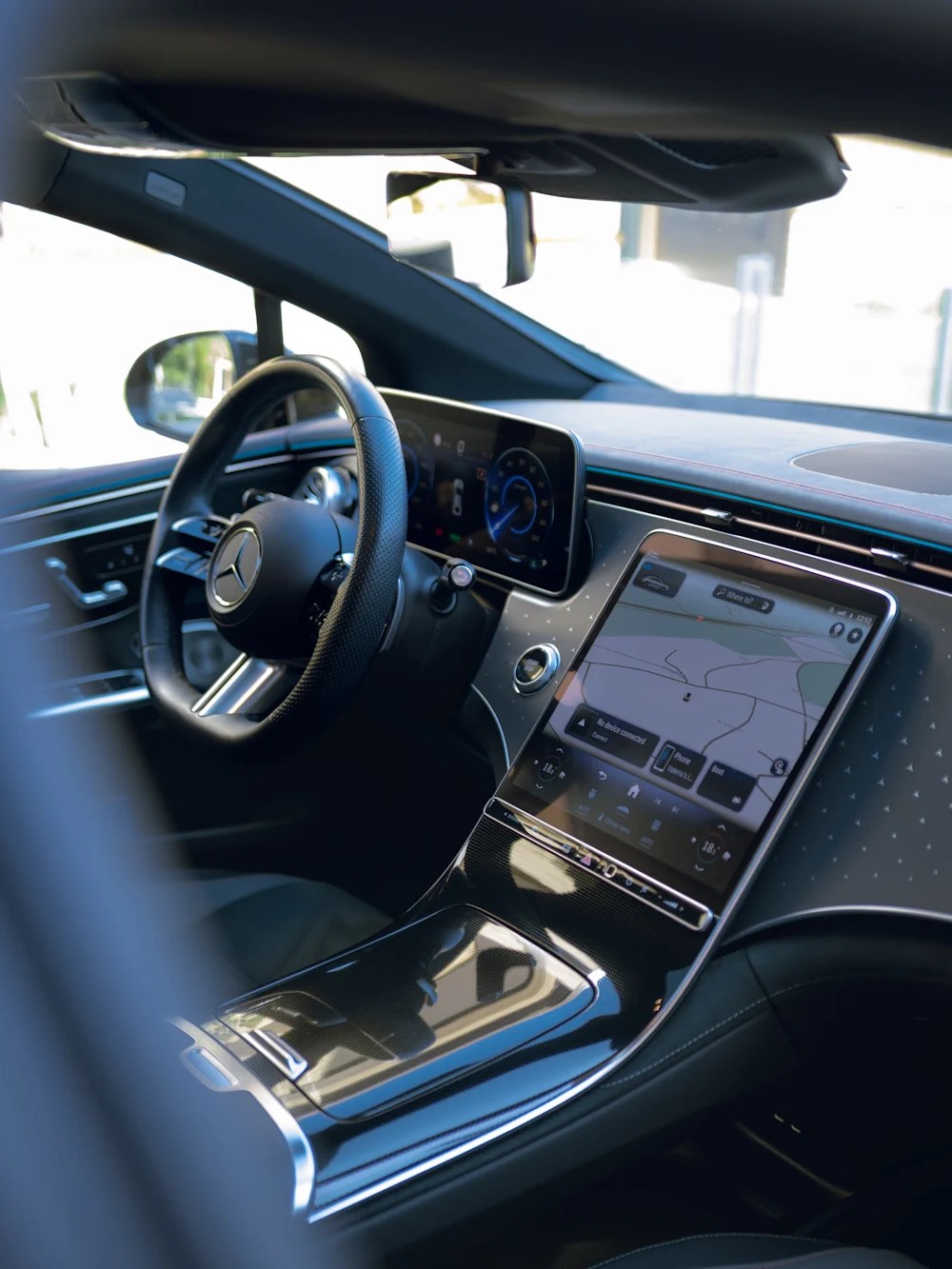 Cockpit of the Mercedes EQE seen through the open driver's door