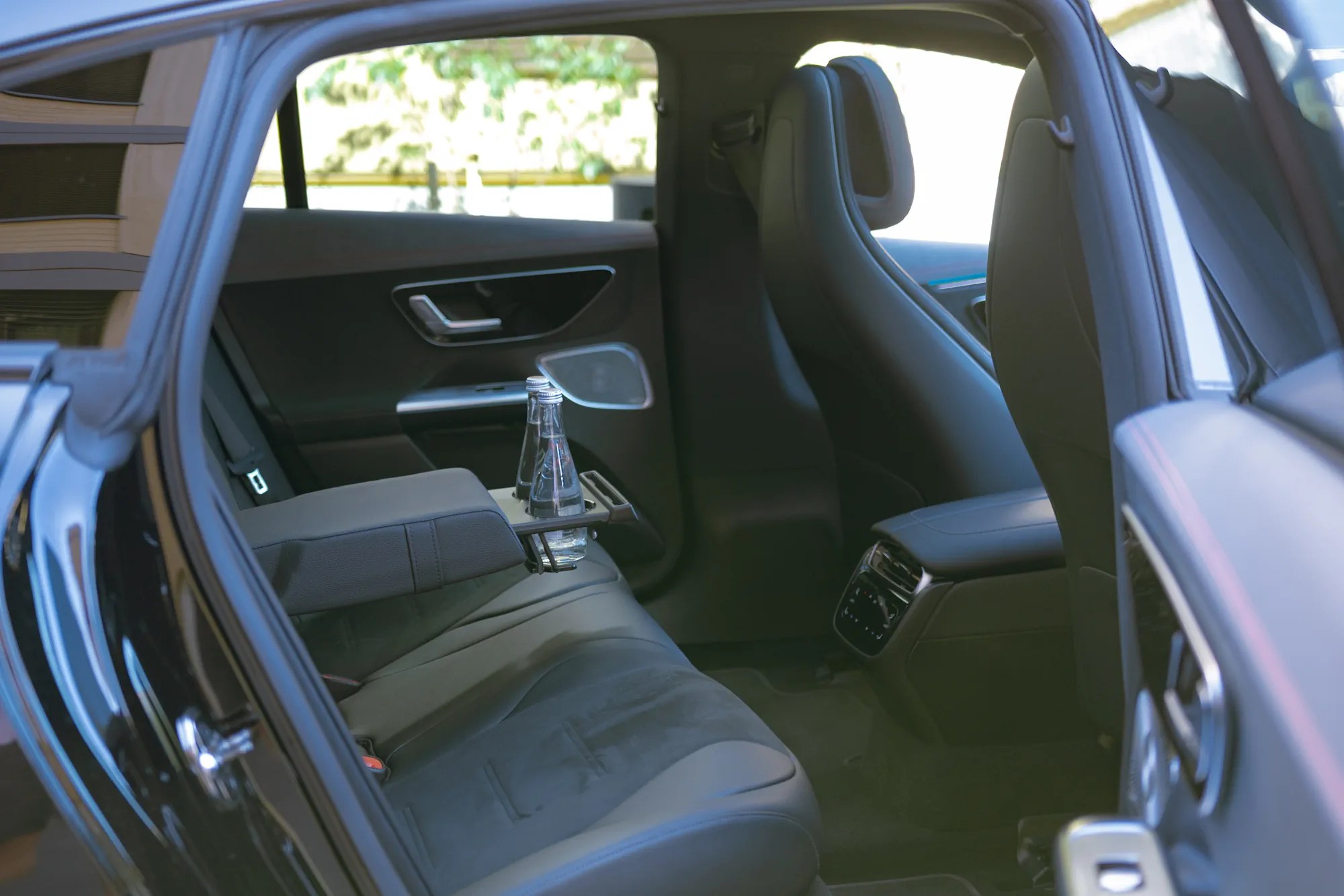 Rear bench of the Mercedes EQE seen through the open rear door