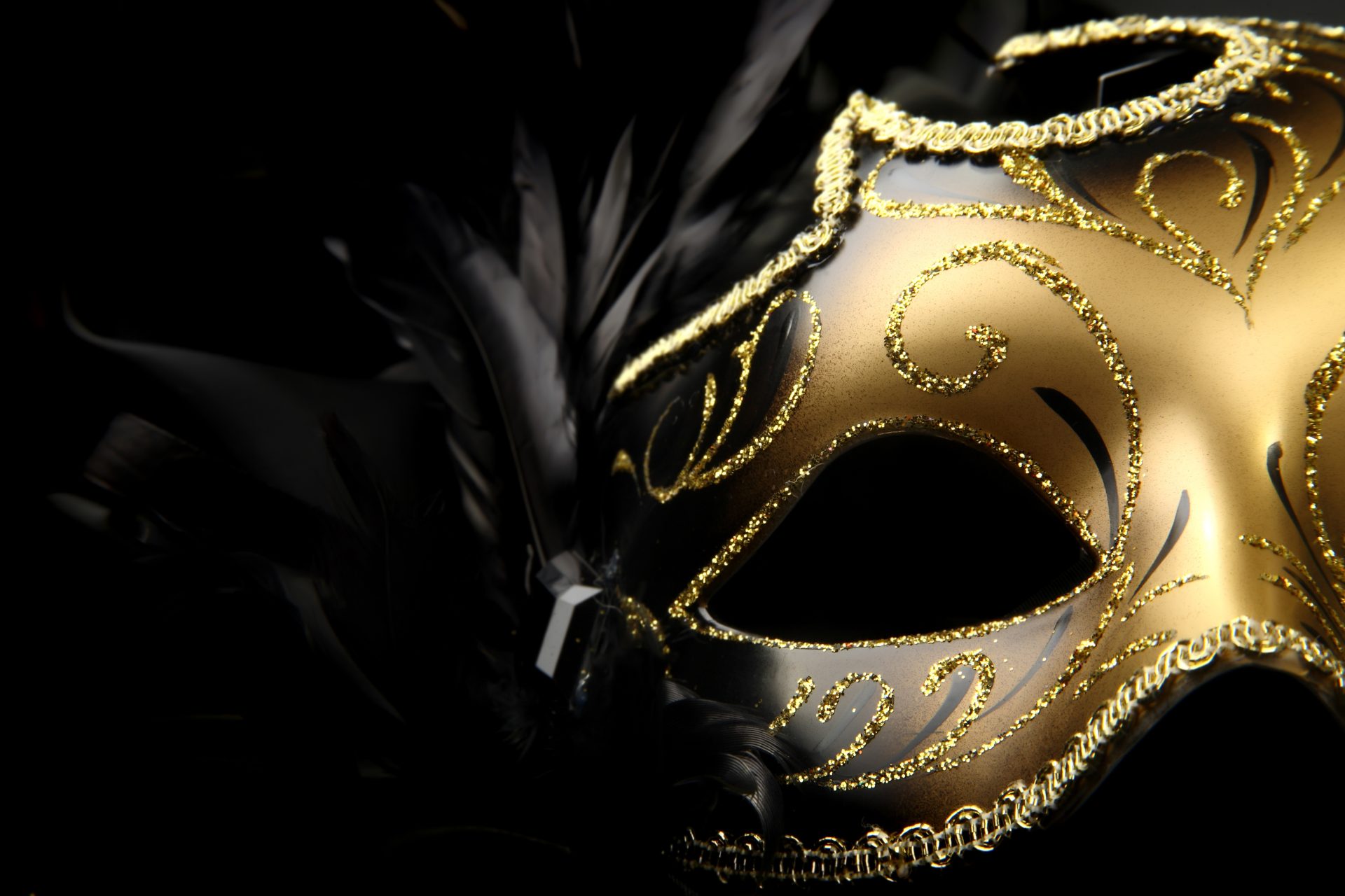 ornate carnival mask over black silk background