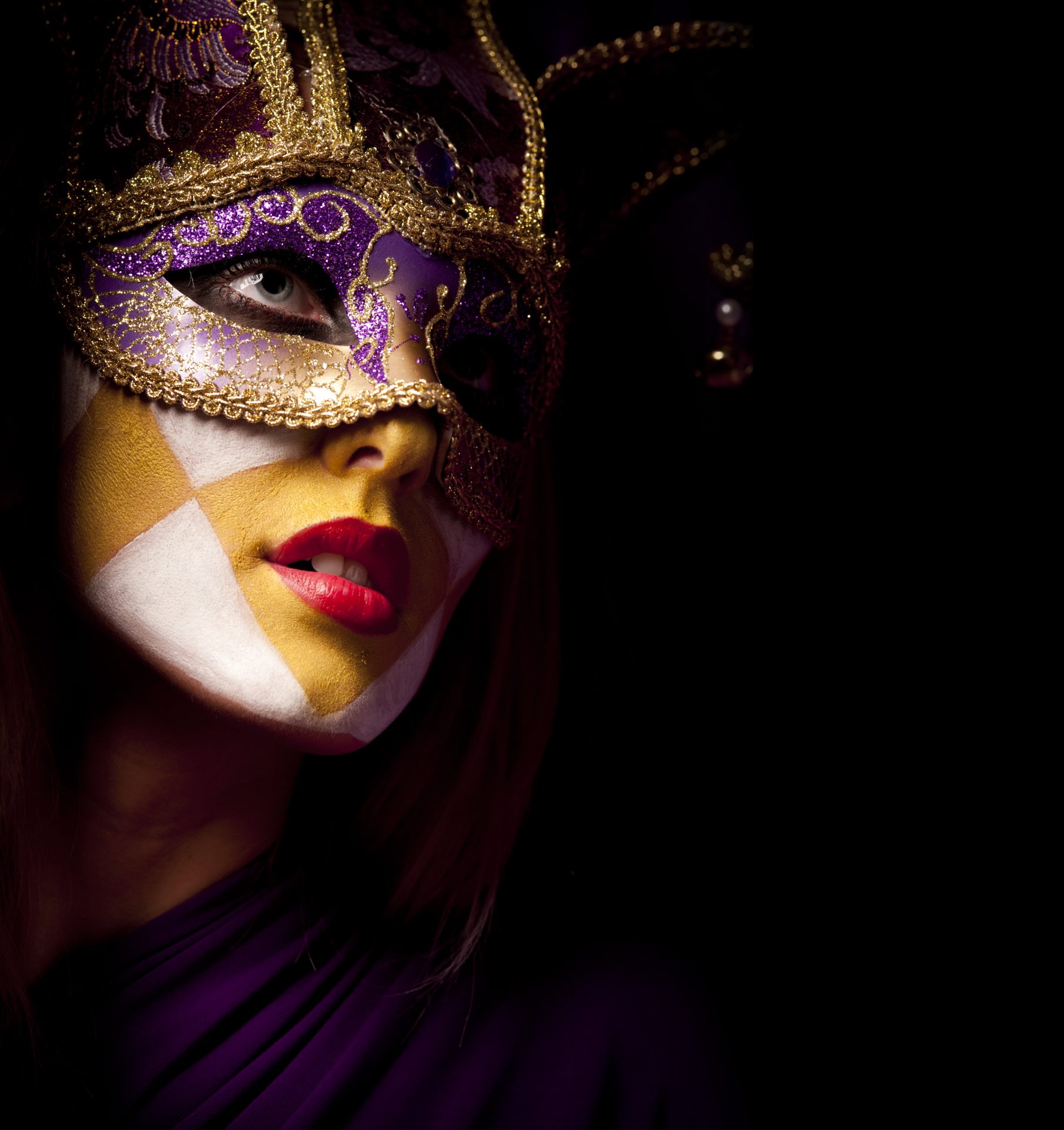closeup portrait of sexy woman in violet party mask for desire concept