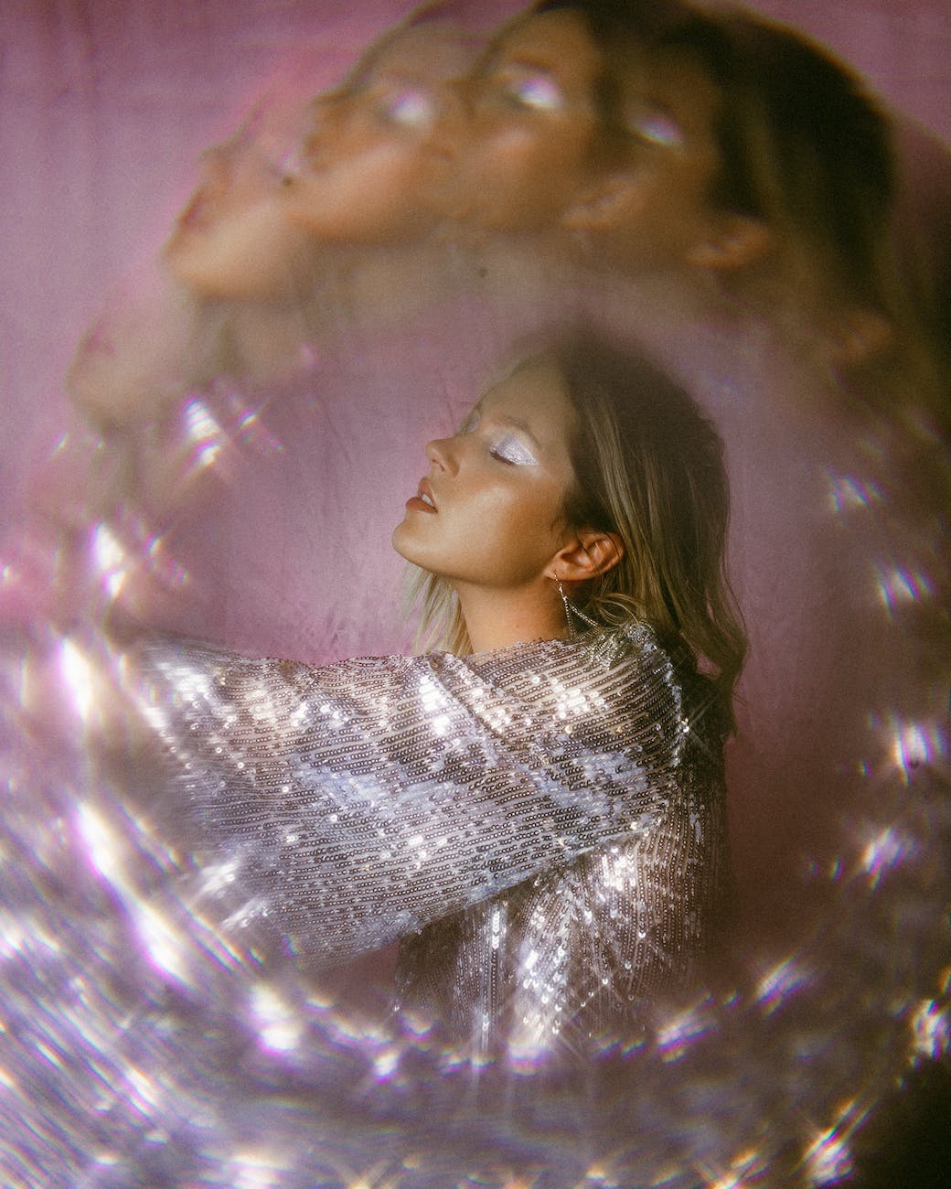 shallow focus photo of woman in silver top