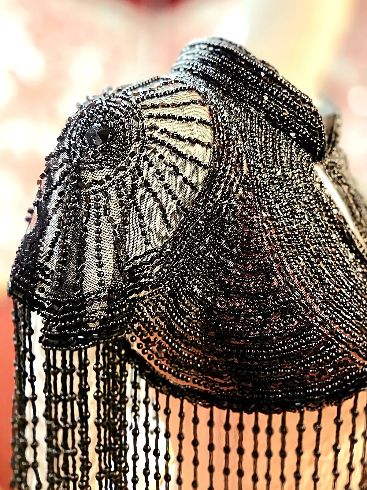 Sort perlekappe med fine perler og elegante detaljer.