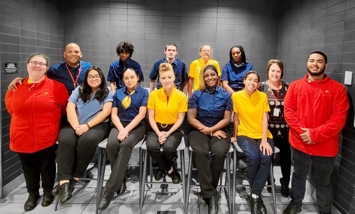 McDonald’s restaurant team members posing together in uniform.