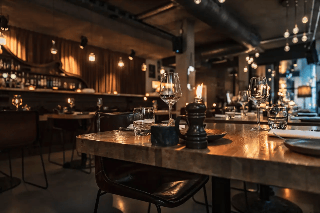 Restaurant interior with a long bar and pendant lighting
