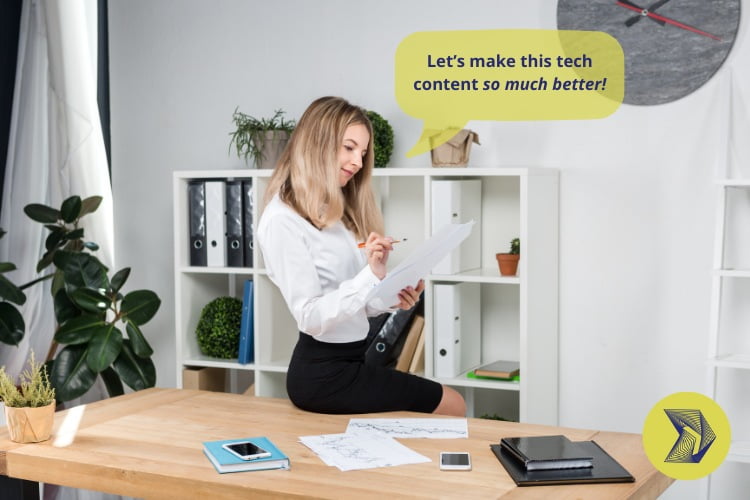 A woman editing a document while sitting on a desk. She says, "Let's make this tech content so much better."