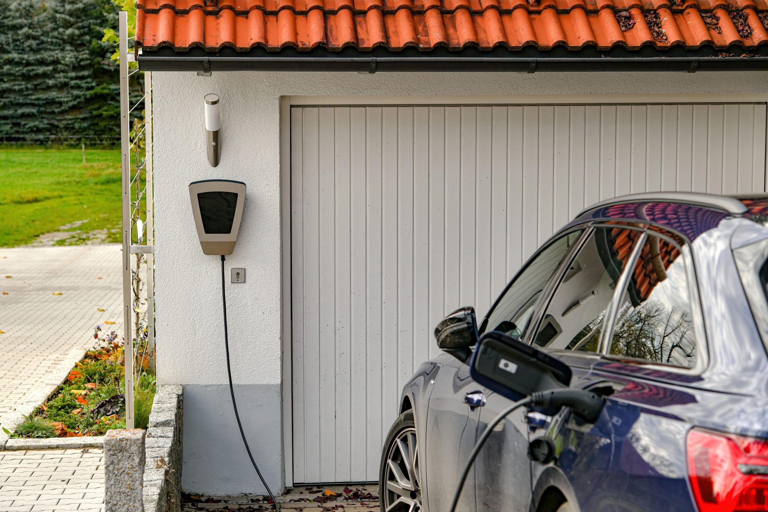 An electric car is charged from a gas station in a private house.