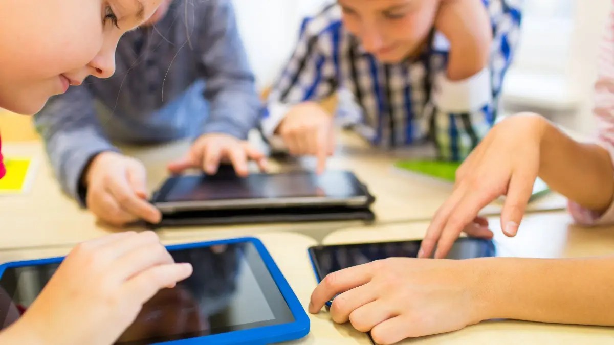 Children viewing tablets