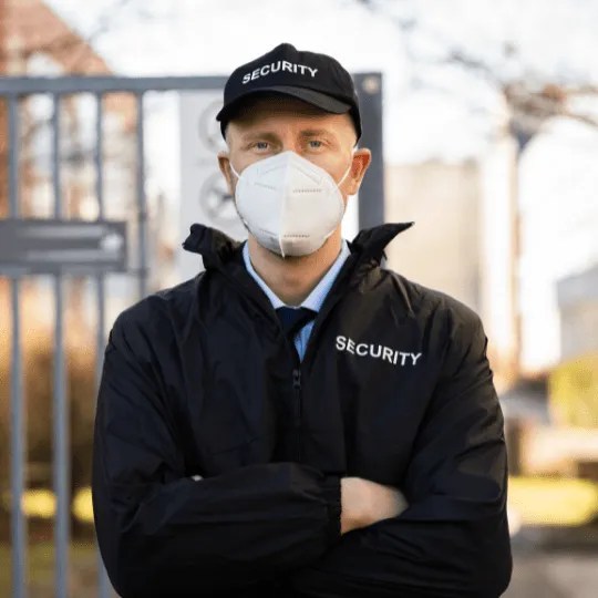 Security officer standing performing security officer service.