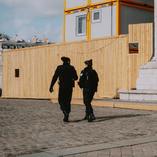 Two woman performing a security patrol in the evening.
