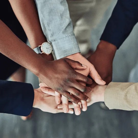 A group of people holding hands.