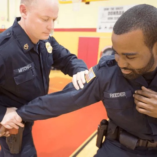 Security schools teaching de-escalation techniques.