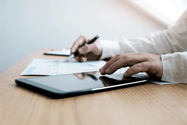 A person writing down a livescan appointment.