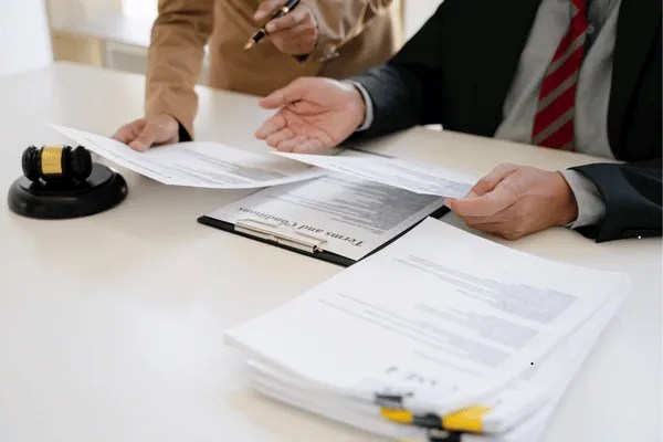 Two people looking at paperwork.