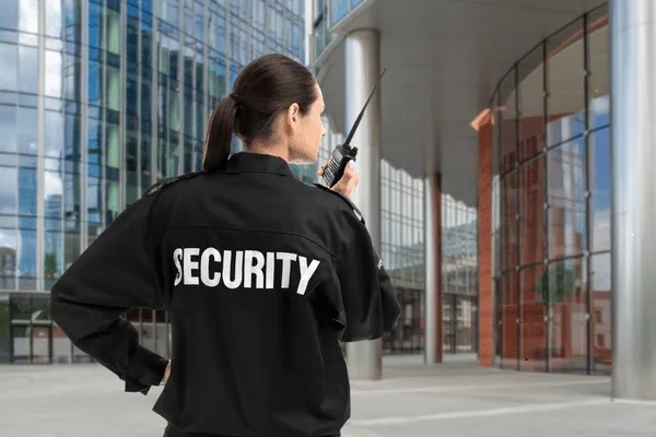 A female security guard part of private security companies walking around.