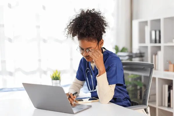 A nurse lady searching fingerprinting services near me on google on her laptop.