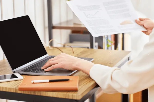 A person using a laptop to create finger printing instructions.