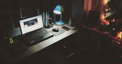 black laptop beside black computer mouse inside room