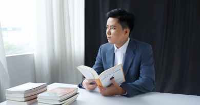 photo of a pensive young man in a suit holding a book