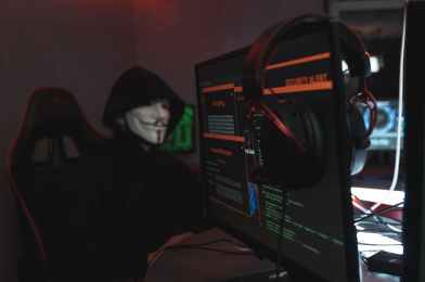 person in black hoodie maybe using ChatGPT hacking a computer system
