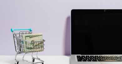 shopping cart next to a laptop
