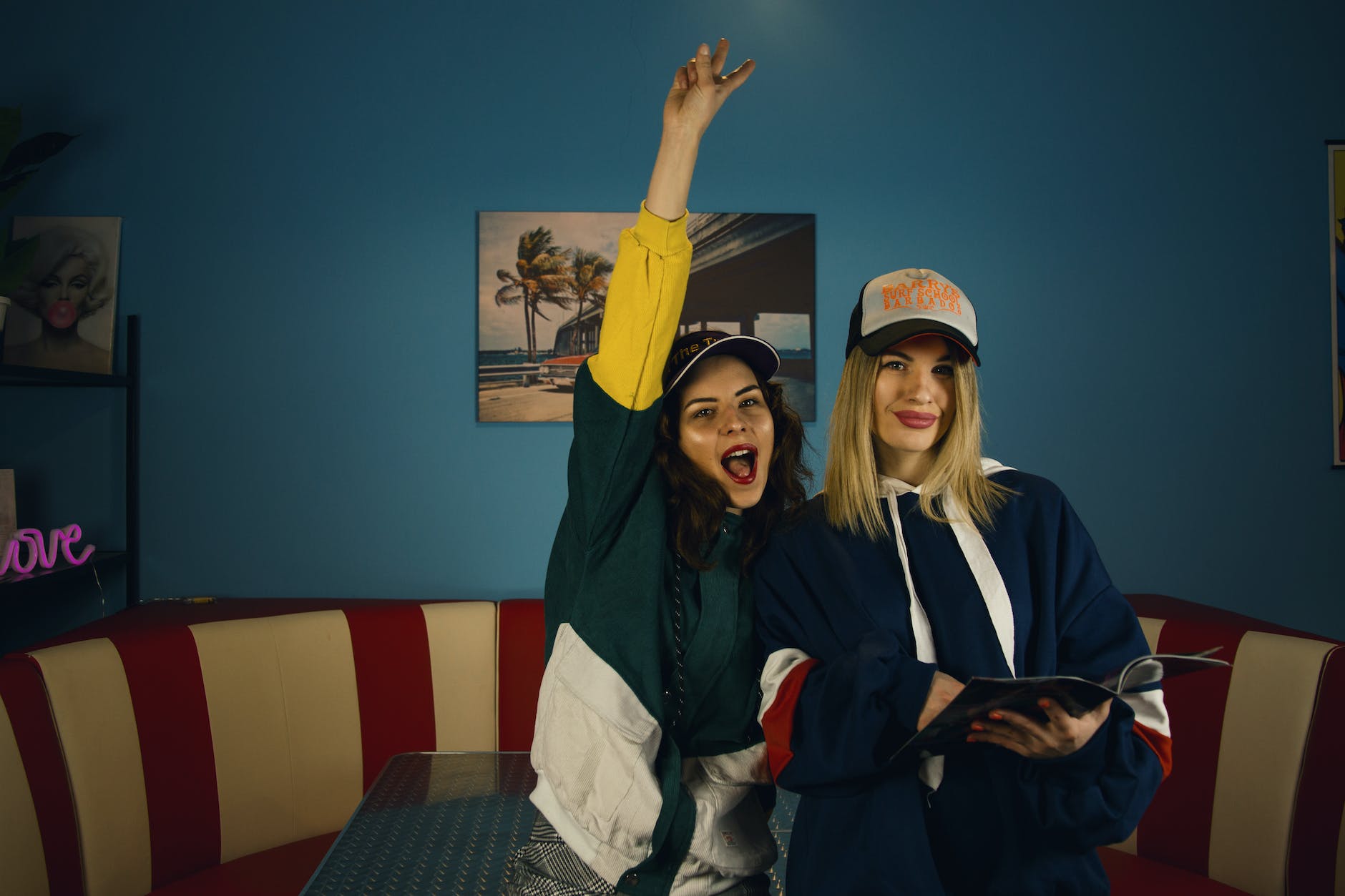 positive young women having fun in old fashioned diner