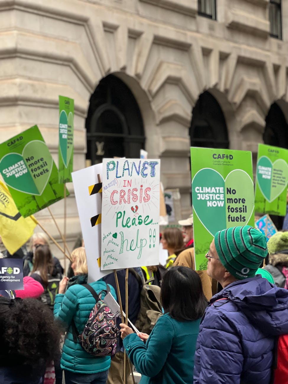 climate protesters with placards outside official building