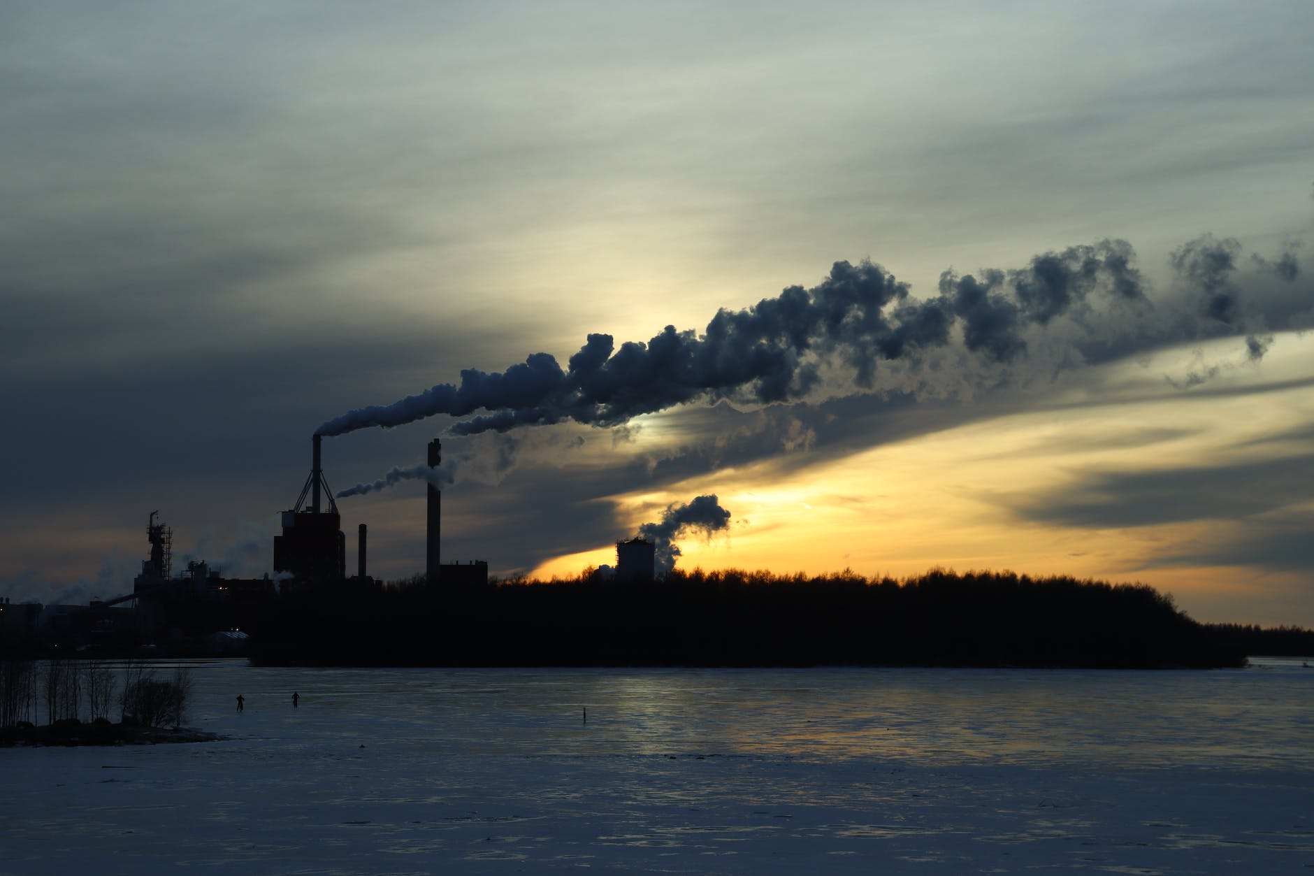 smoke from chimneys on coast at sunset in winter