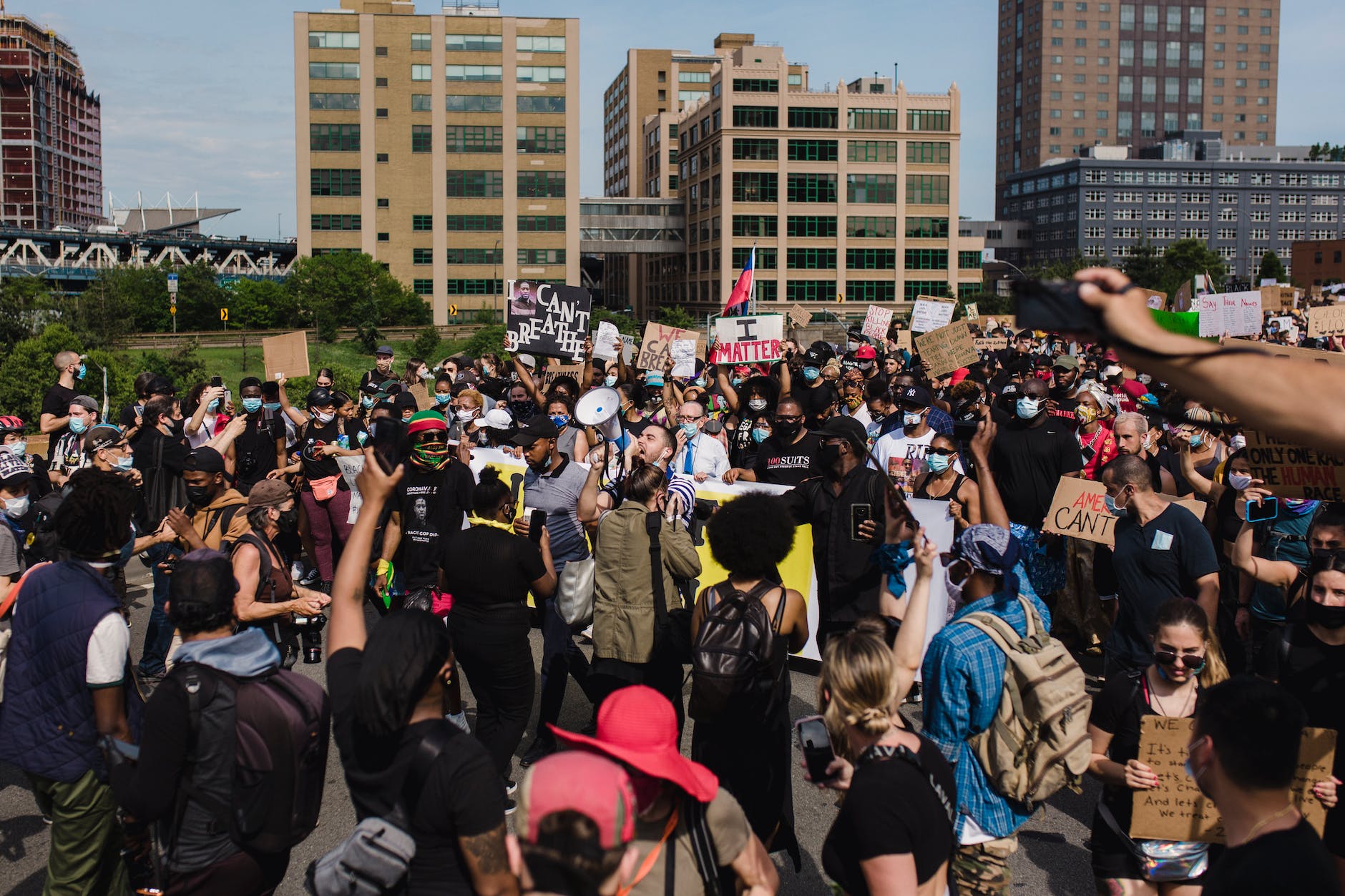 crowd of protesters holding signs