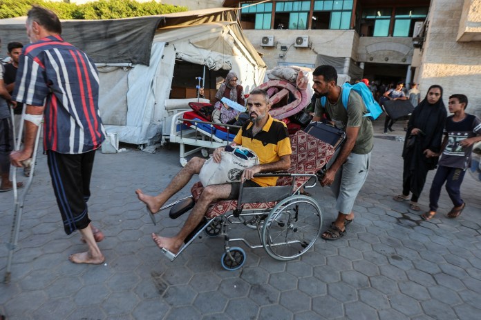 Families Crowd Evacuation Corridors In Gaza City Displaced families push strollers and wheelchairs through a packed evacuation corridor in Gaza City
