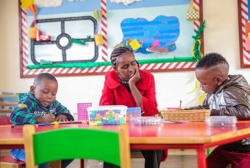 Eban Rock Kindergarten Teacher with some scholars learning some math. Eban Rock Kindergarten Teacher with some scholars learning some math.
