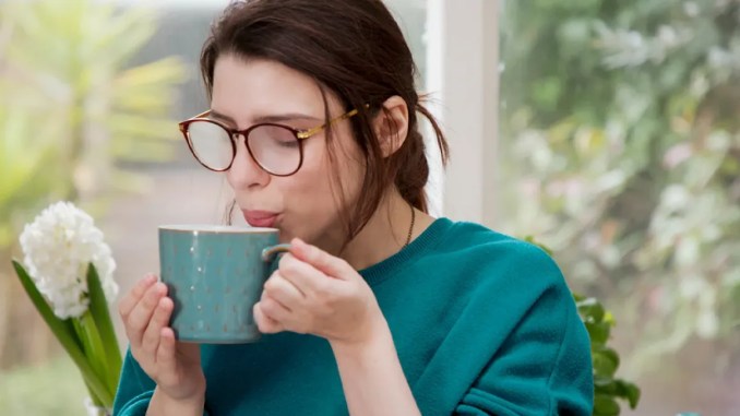 Woman-is-blowing-into-hot-drink-1296x728-header