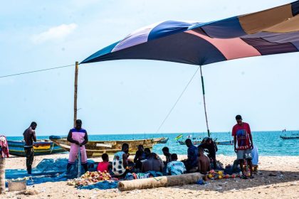 Stranded fishermen wearing long looks on the Lekki seashore
