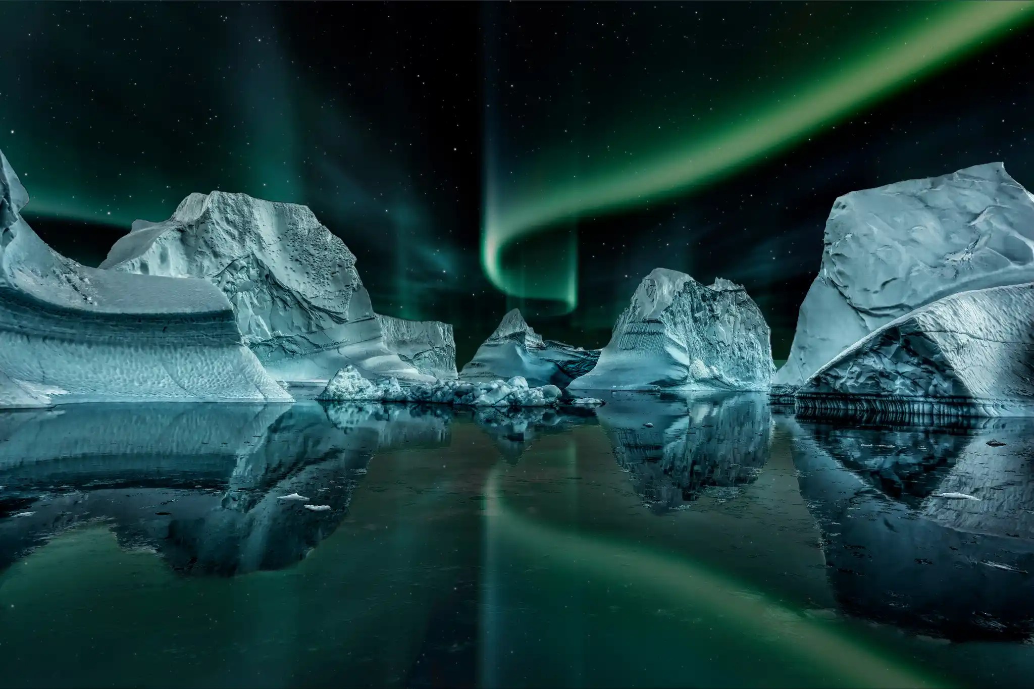 Northern lights aurora borealis dancing over icebergs floating in calm Arctic waters with reflections