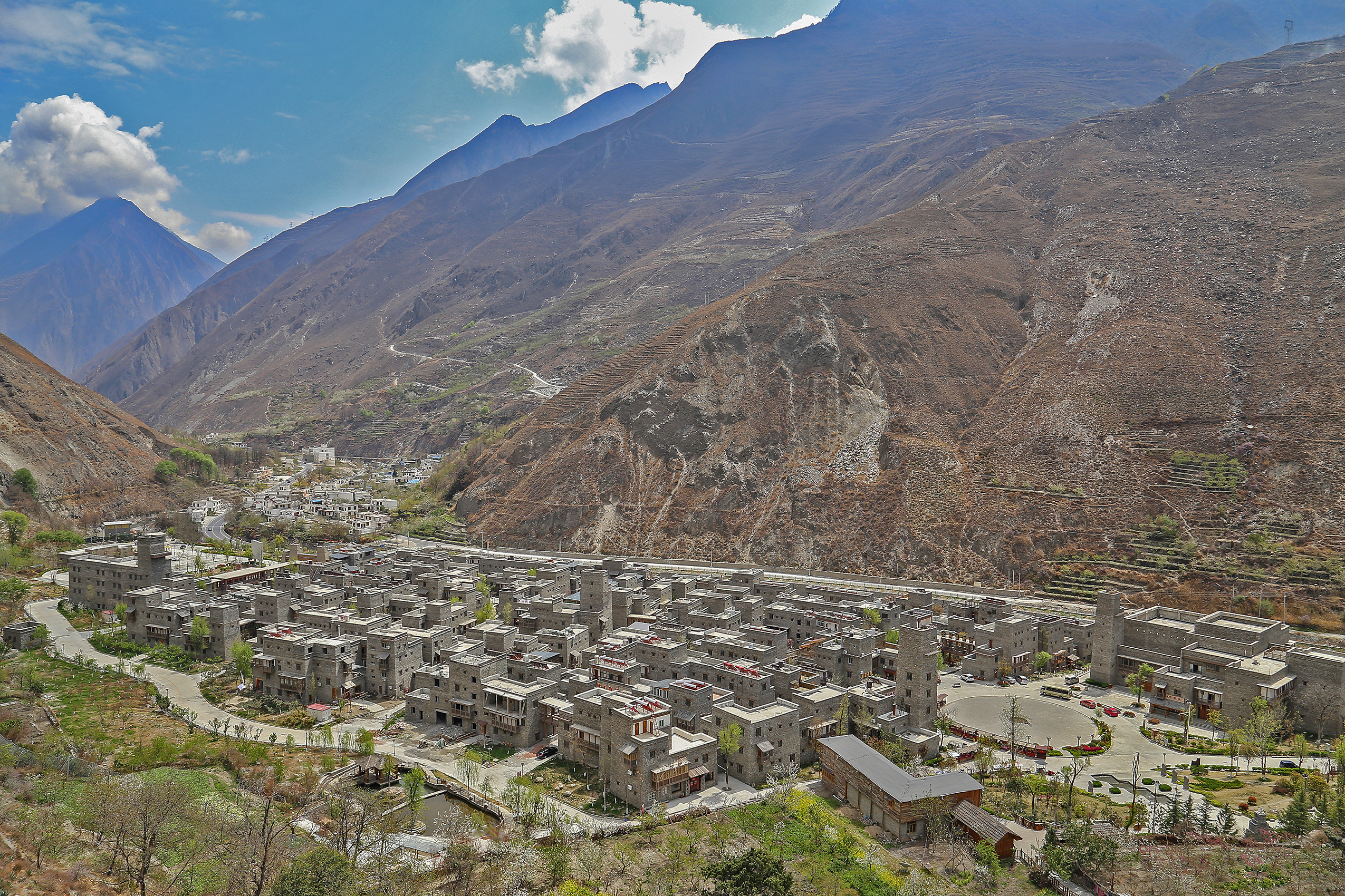 Aerial view of Taoping, a Qiang stone village of tightly clustered stone houses and watchtowers set in a Sichuan mountain valley