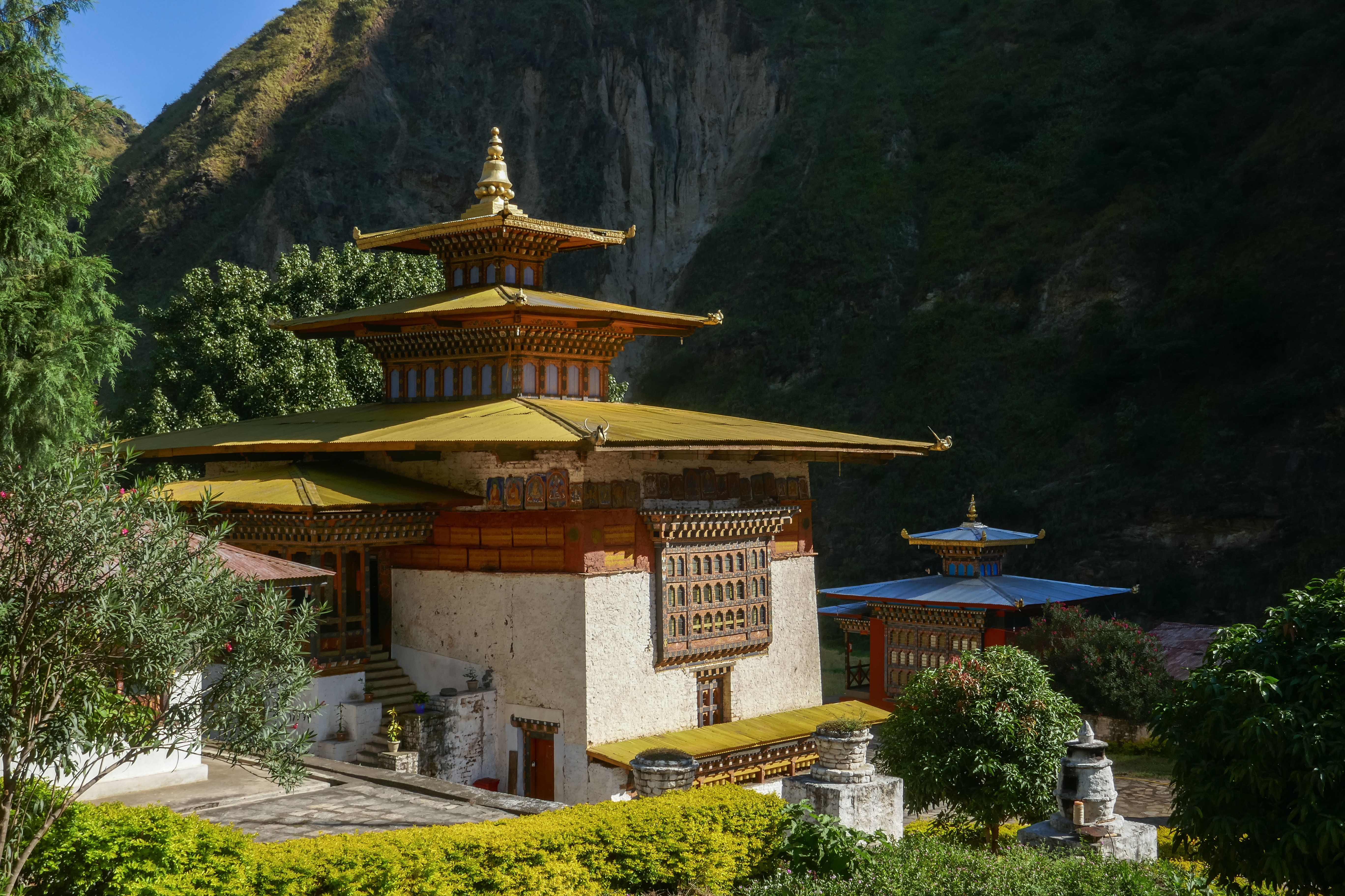 Landscape view of beautiful Gom Kora or Gomphu Kora buddhist temple against dark mountain background, near Trashigang, eastern Bhutan