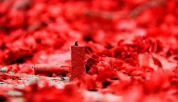 a firecracker standing in a pile of firecracker confetti