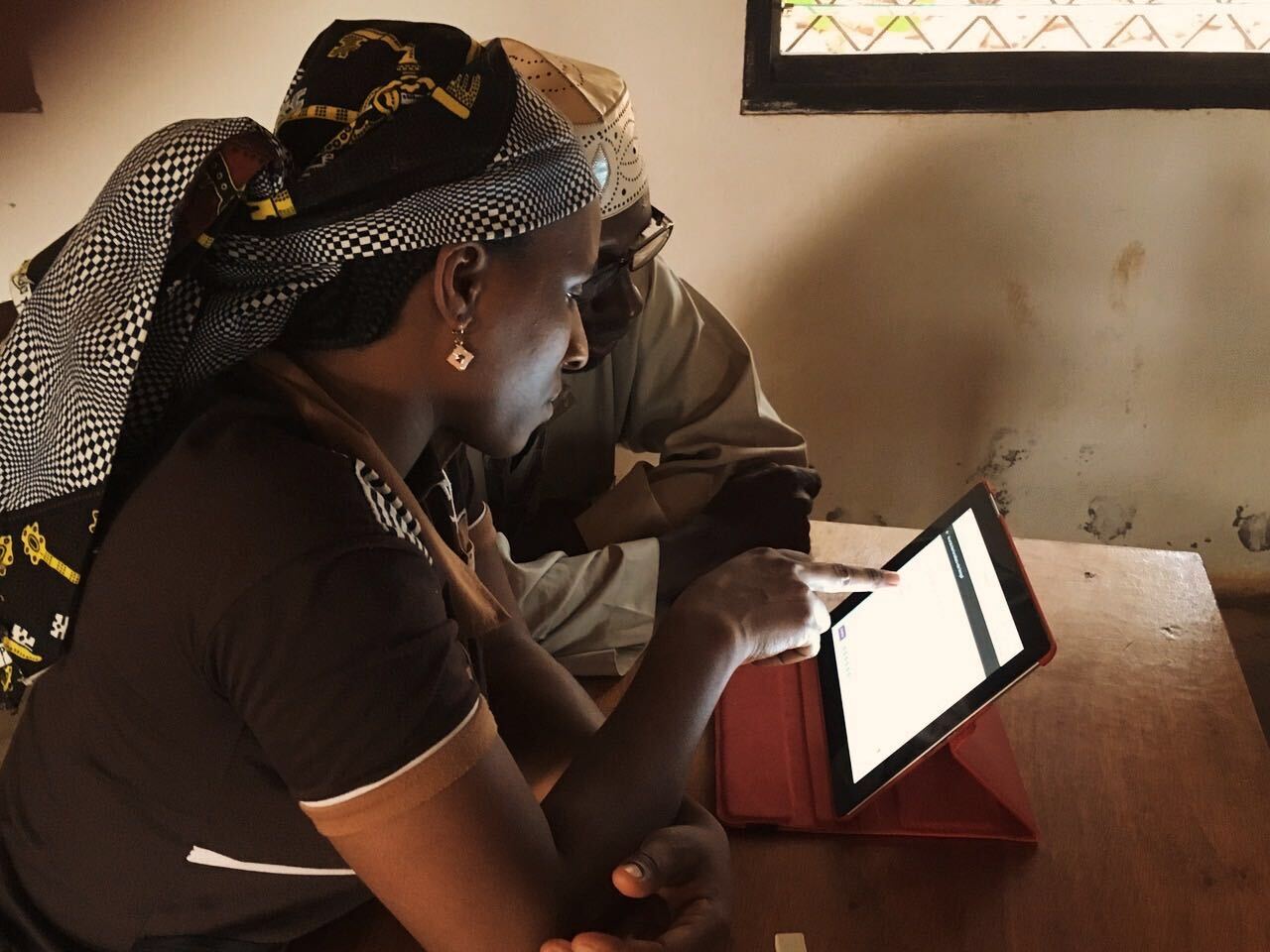 A man and woman using a laptop